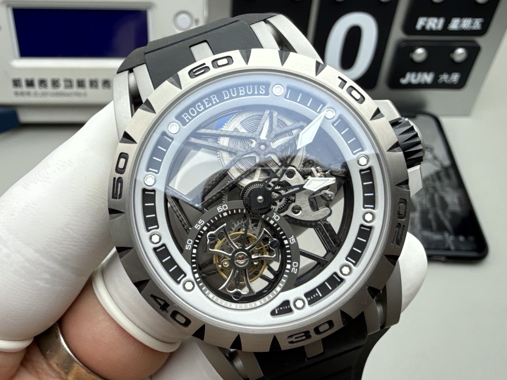 Elevate your collection with the Roger Dubuis Excalibur Spider RDDBEX0545, a bold statement of Swiss haute horlogerie and motorsport-inspired design. Designed for the modern connoisseur who craves both visual drama and mechanical mastery, this 45mm timepiece features a fully skeletonized dial, exposing every intricate detail of the in-house RD509SQ flying tourbillon movement. The iconic open framework, paired with a vibrant red-accented inner bezel and red DLC-coated crown, captures the adrenaline of the racetrack, while the lightweight grade 5 titanium case ensures comfort without compromising durability. Protected by an anti-reflective sapphire crystal, the watch offers crystal-clear visibility of the movement’s hand-finished bridges, gears, and the mesmerizing flying tourbillon at 6 o’clock. The integrated black rubber strap with a secure folding clasp provides a sporty, ergonomic fit, ideal for both formal occasions and active lifestyles.